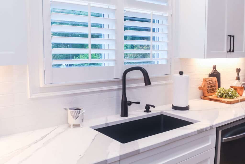 kitchen sink update with Cambria Brittanicca quartz countertop and Delta Stryke kitchen faucet