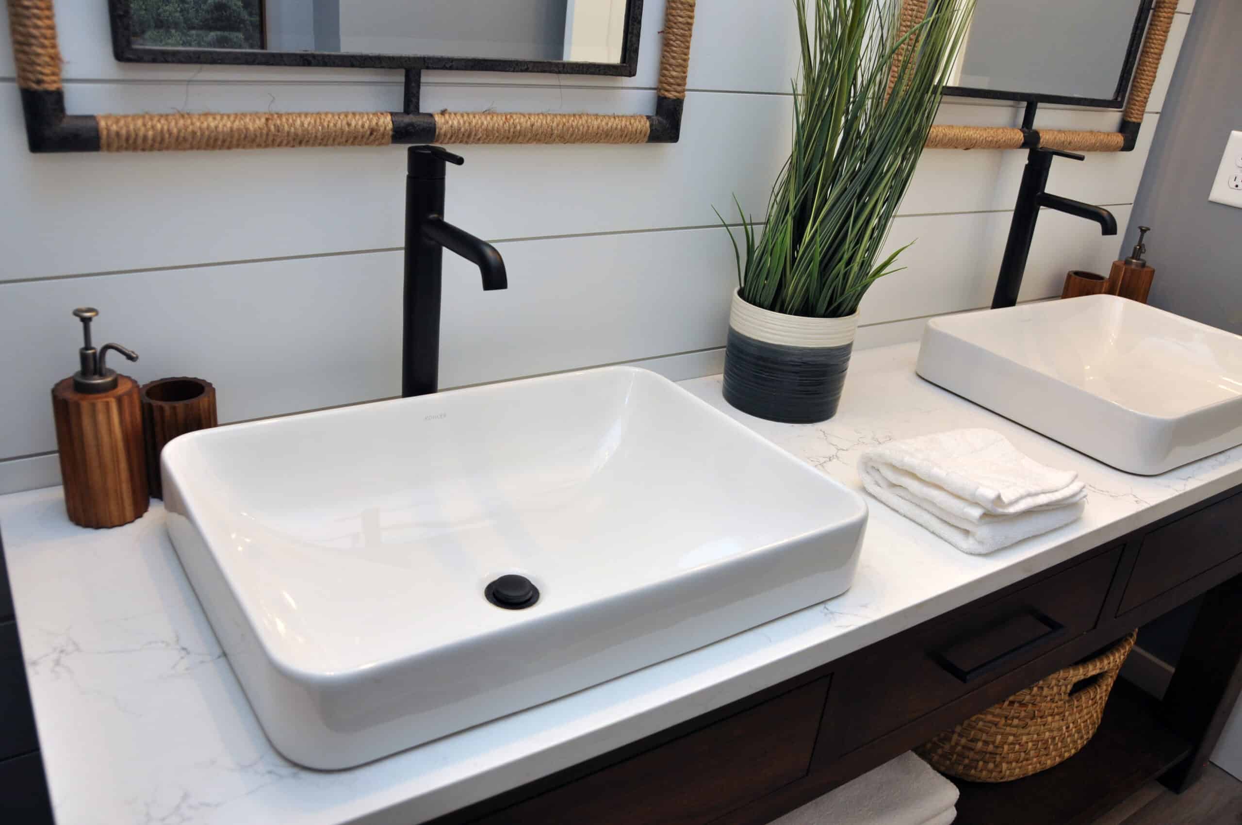 Two sinks side by side with black and white theme