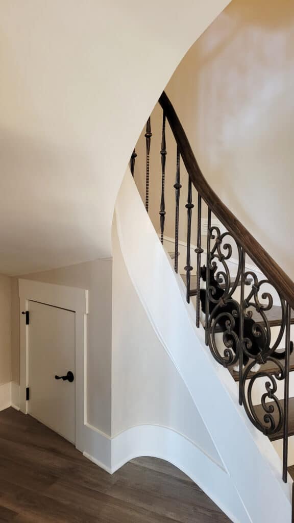 Sweeping staircase in basement remodel