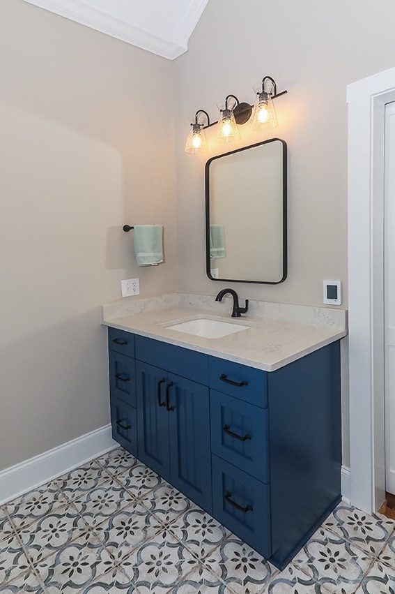 Blue bathroom vanity cabinet with tiled flooring
